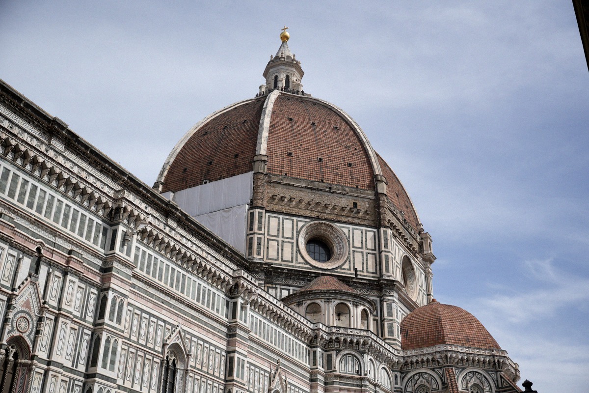 Brunelleschi's dome on Florence Cathedral in close-up, with the gilded cross on the lantern.