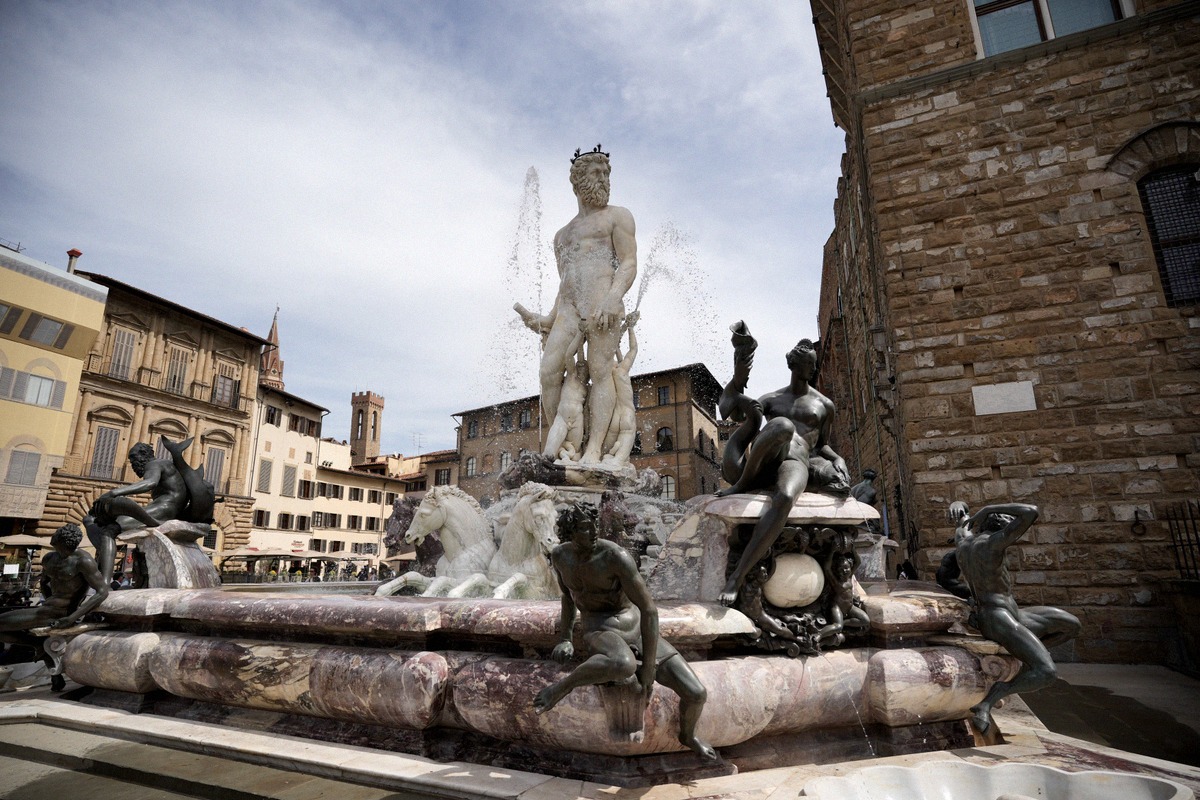 The Fountain of Neptune on Piazza della Signoria with the white marble statue and the bronze nymphs.